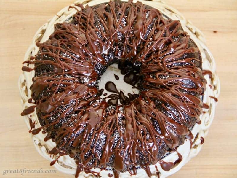 Overhead view of drizzled cake with chocolate frosting.