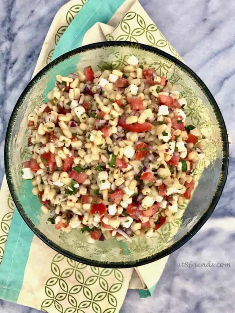 Overhead shot of Corn Salad in a green glass bowl.