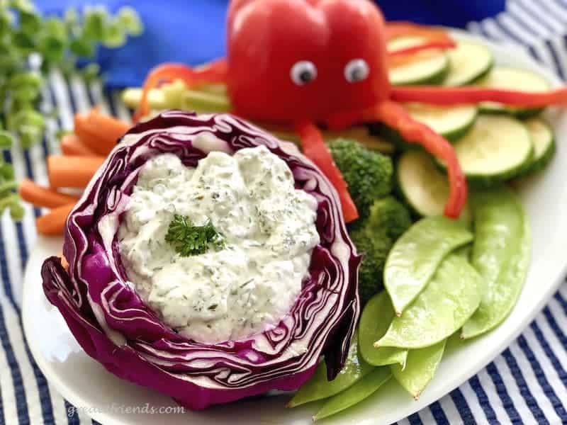 Herby Dill Dip in a cabbage bowl with veggies.