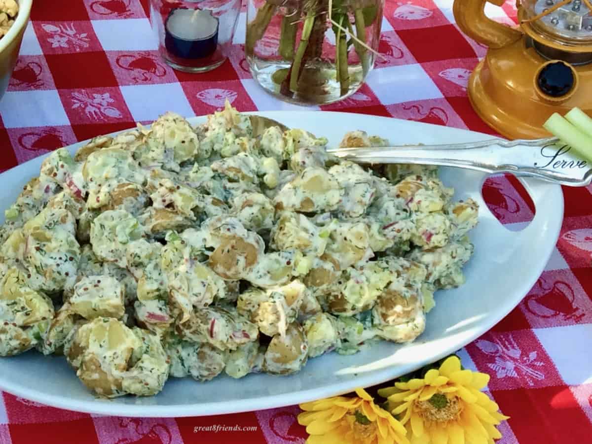 Potato salad on a white platter.