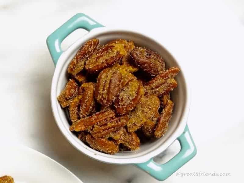 Sugar and Spice Pecans, overhead shot of nuts in blue dish.