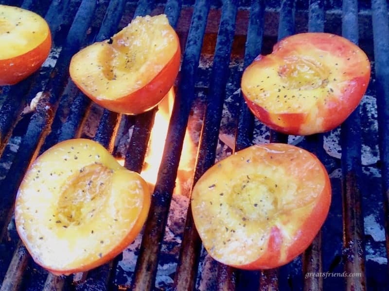 Nectarine halves on a fired up grill.