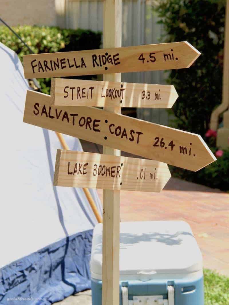 Four wood signs used as a decoration for the camping themed dinner party.