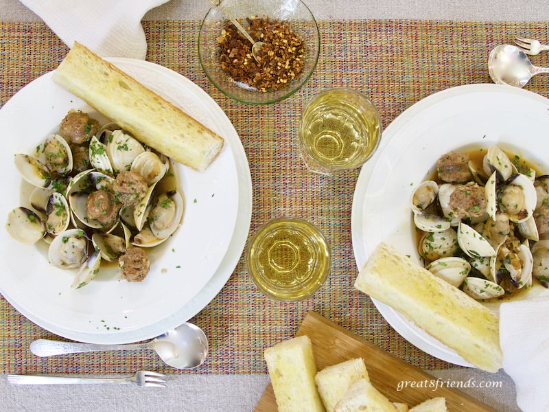Clams with Hot Italian Sausage for two, overhead shot with wine and pepper flakes and bread