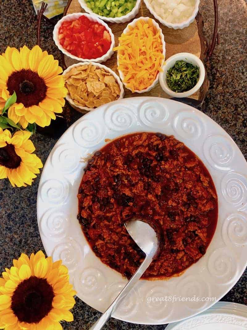 Turkey chili with toppings and sunflowers.