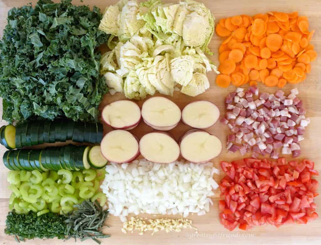 Vegetables chopped and arranged on a wooden board.