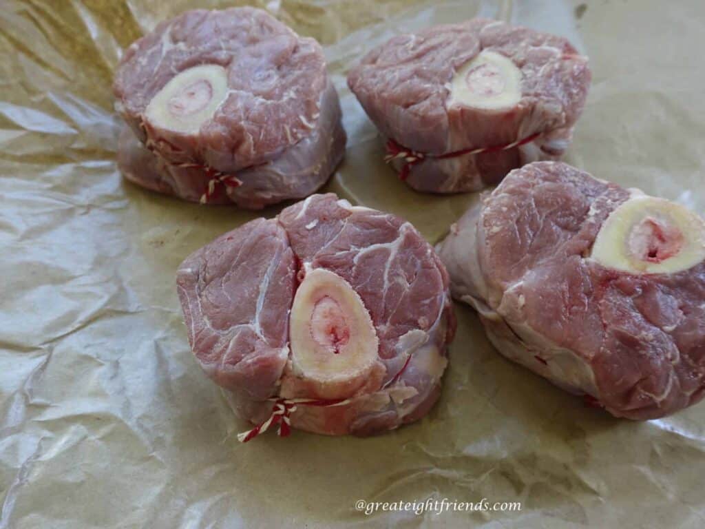 Uncooked cross cut veal shanks.