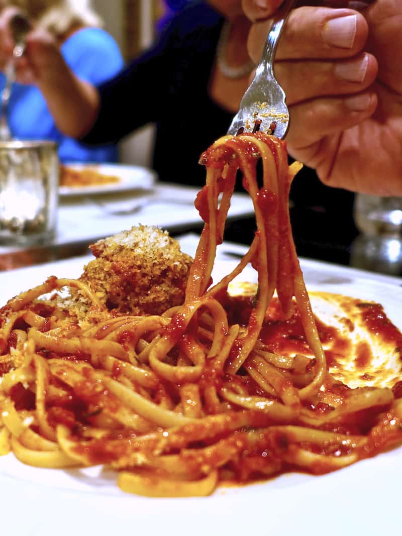 A fork holding spaghetti and sauce.