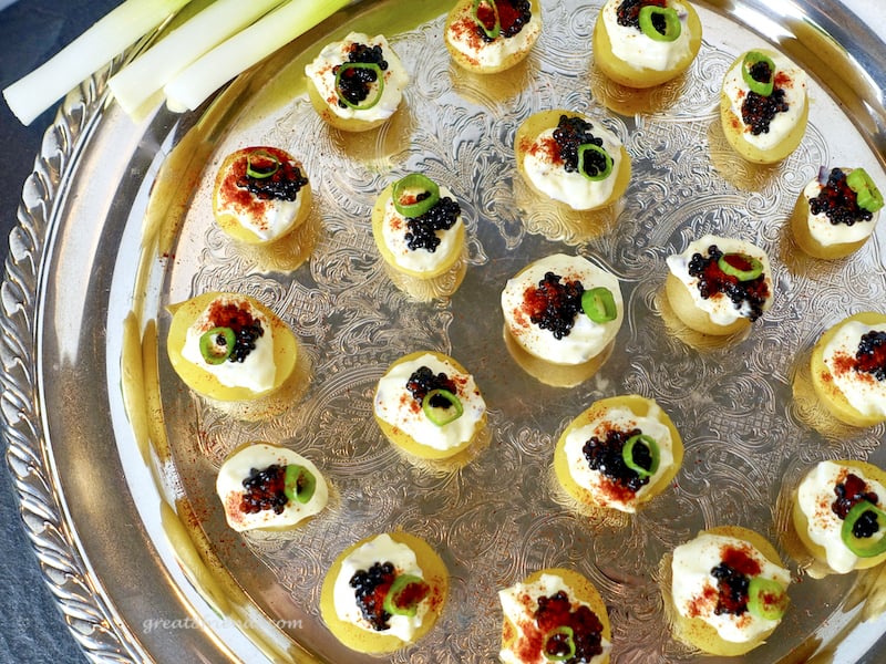 This Caviar with Cream on Baby Potatoes is an elegant and easy way to serve caviar to a crowd. A small bite without the assembly mess!