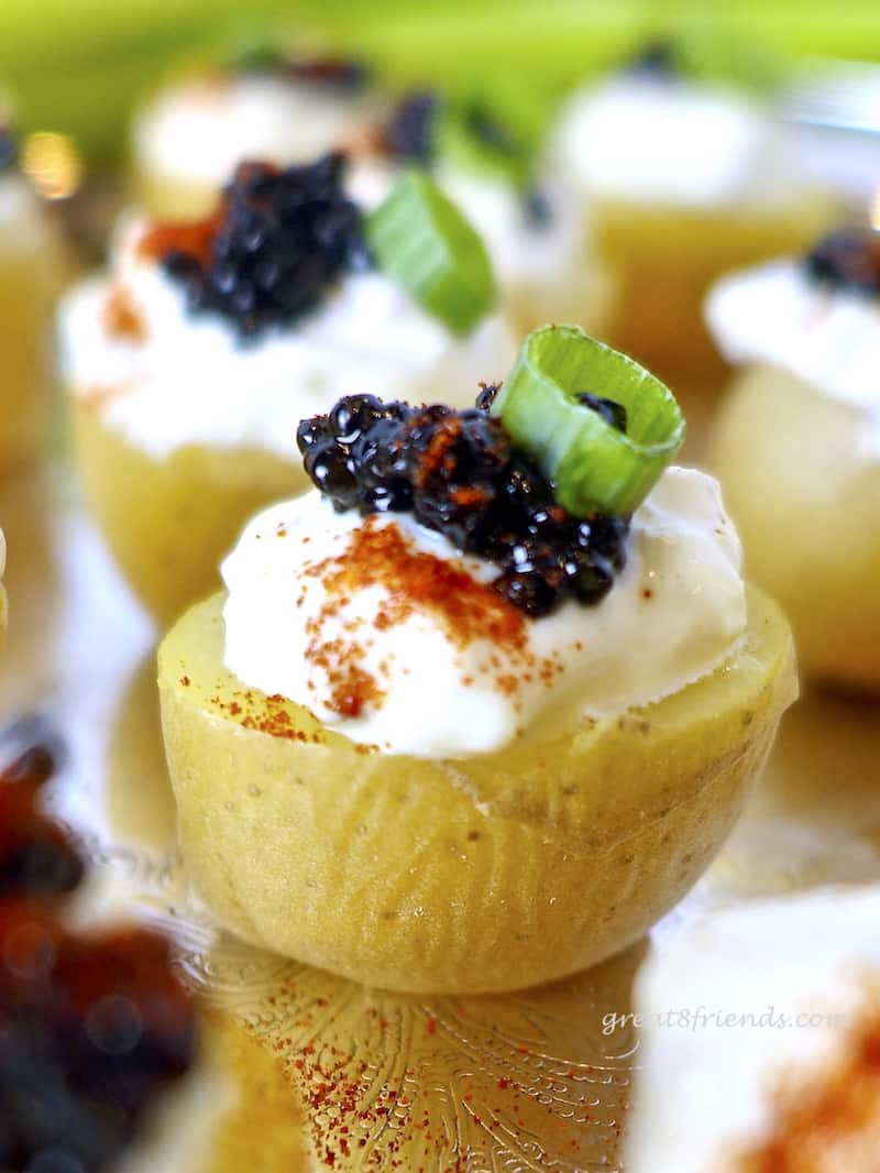 This Caviar with Cream on Baby Potatoes is an elegant and easy way to serve caviar to a crowd. A small bite without the assembly mess!