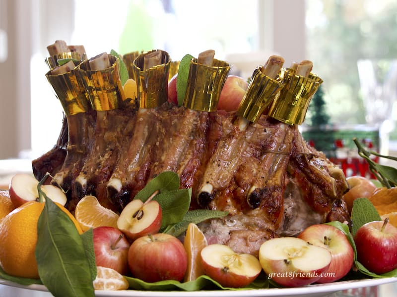 Crown Roast of Pork surrounded by apples and tangerines, horizontal