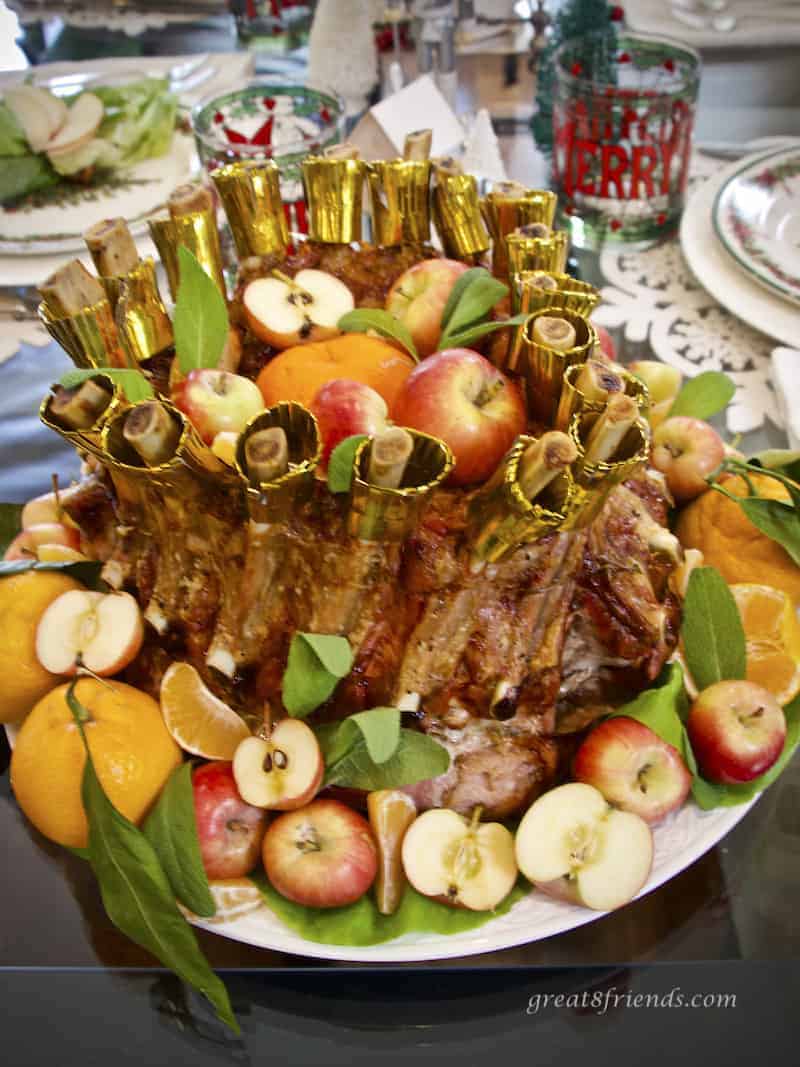 Crown Roast of Pork stuffed and surrounded with apples and tangerines, verticle photo