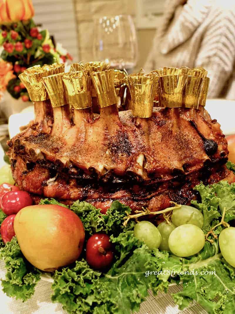 Crown Roast of Pork surrounded by fruit.