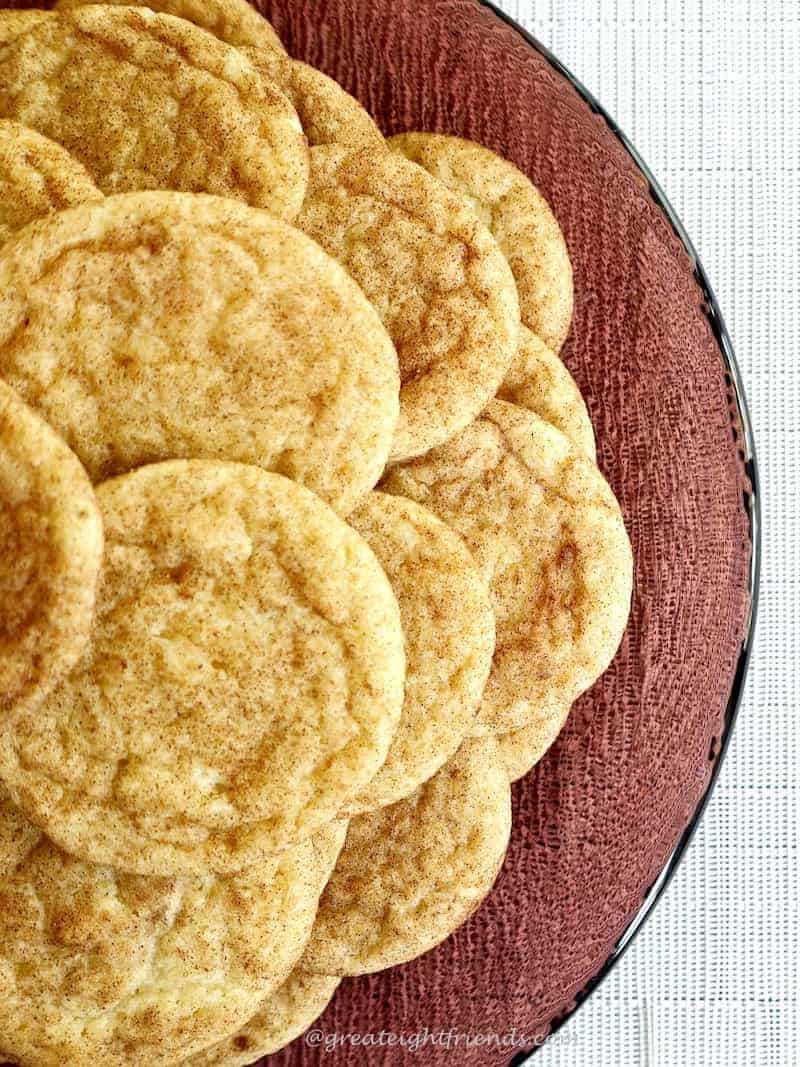 Snickerdodles Stacked on a purple glass Plate.