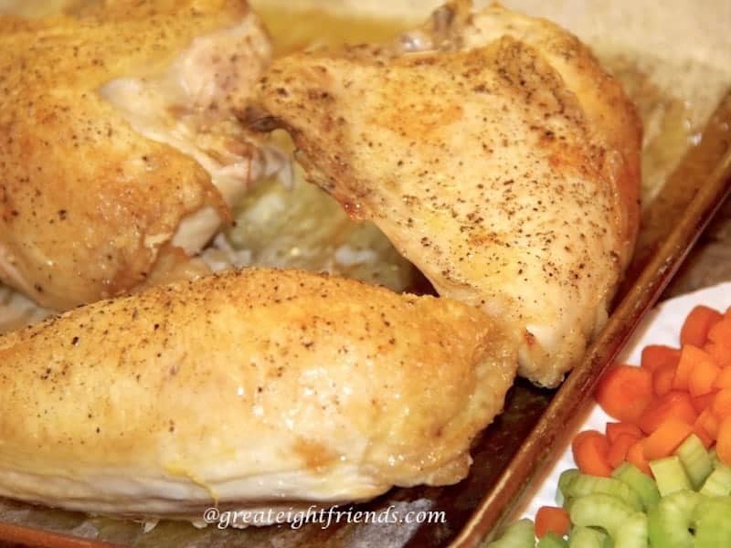 Chicken breasts on baking sheet.