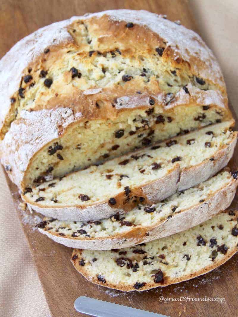 A loaf of Irish soda bread with 3 slices.