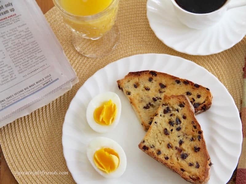 Toasted soda bread on a white plate with two halves of a hard boiled egg.