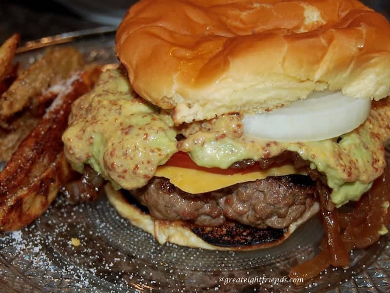 Grilled Hamburger oozing whole grain mustard, onions, and cheese.