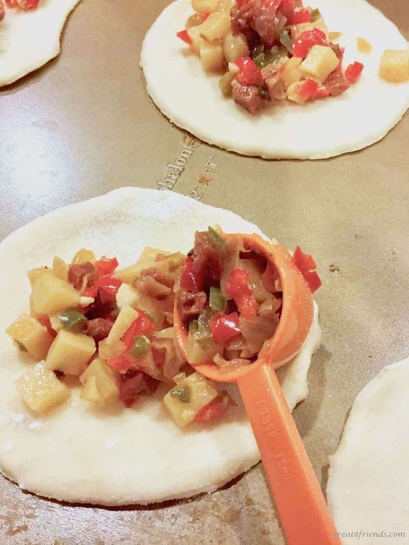 Filling the chorizo empanadas before baking.