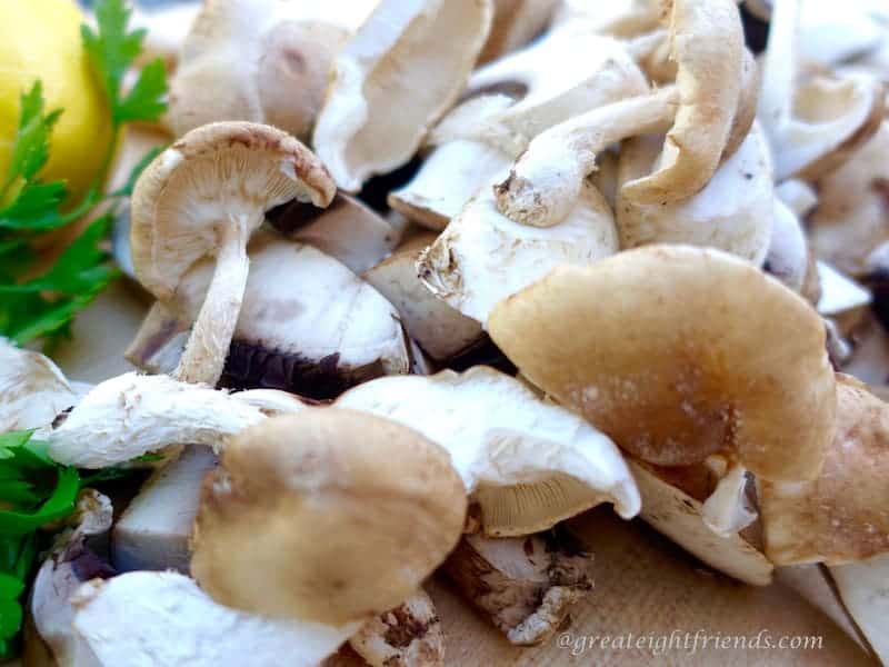 Raw assorted mushrooms ready to chop on the cutting board