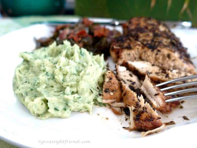 Potato Basil Purée shown on a dinner plate with chicken.