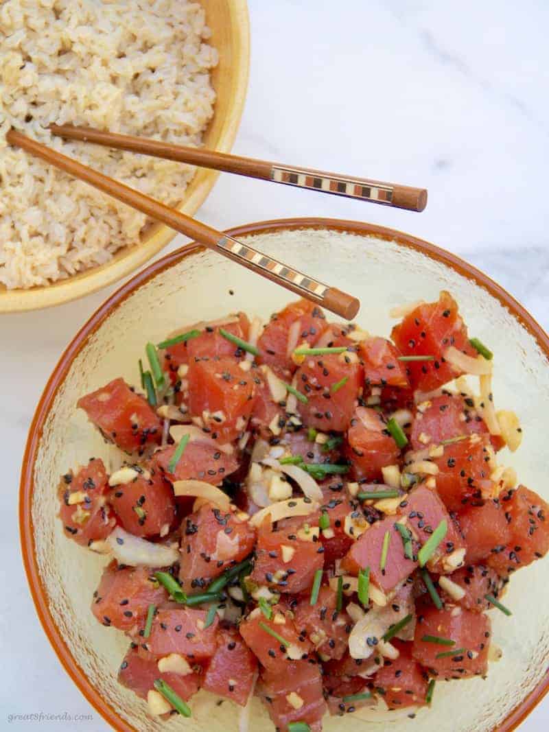 Large bowl of ahi poke with another bowl of brown rice.