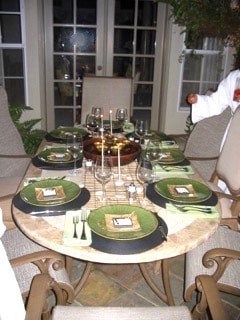 A table set with green plates and a fountain centerpiece.