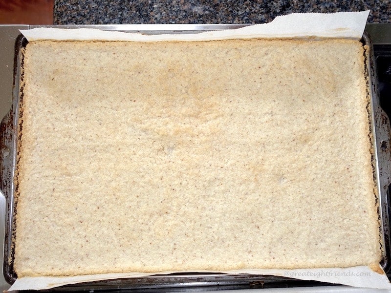 A rectangular crust in a parchment lines tray.