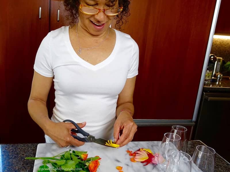 Woman cutting up edible flowers.