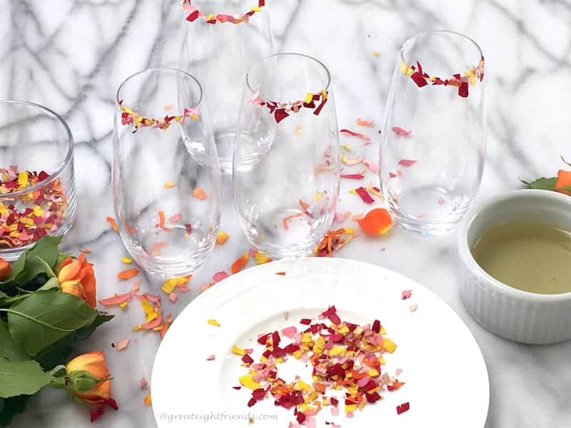 Edible flowers cut into confetti ready to rim stemless flute glasses.