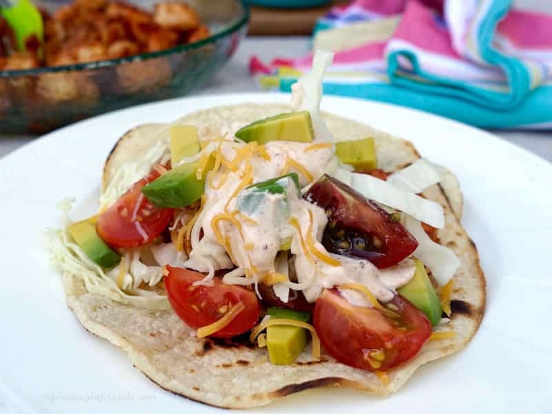 Cajun Shrimp Tacos loaded with tomatoes, avocado and Chili Lime Cream Sauce.