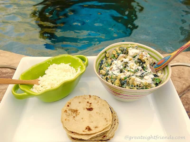 Tortillas and filling on a tray in front of a pool.