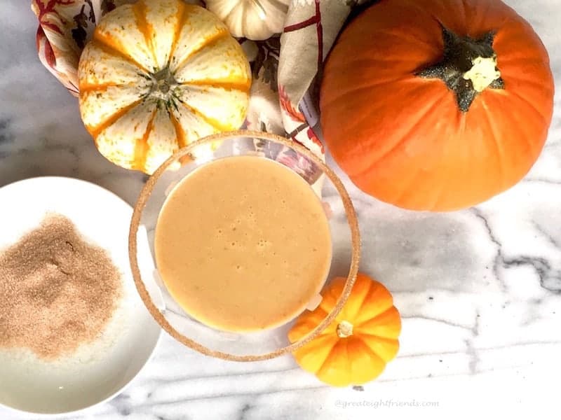 Overhead shot of pumpkins and a cocktail.