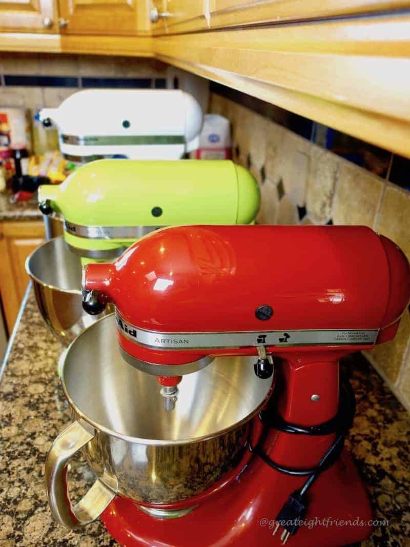 Three different Kitchen Aid mixers lined up.