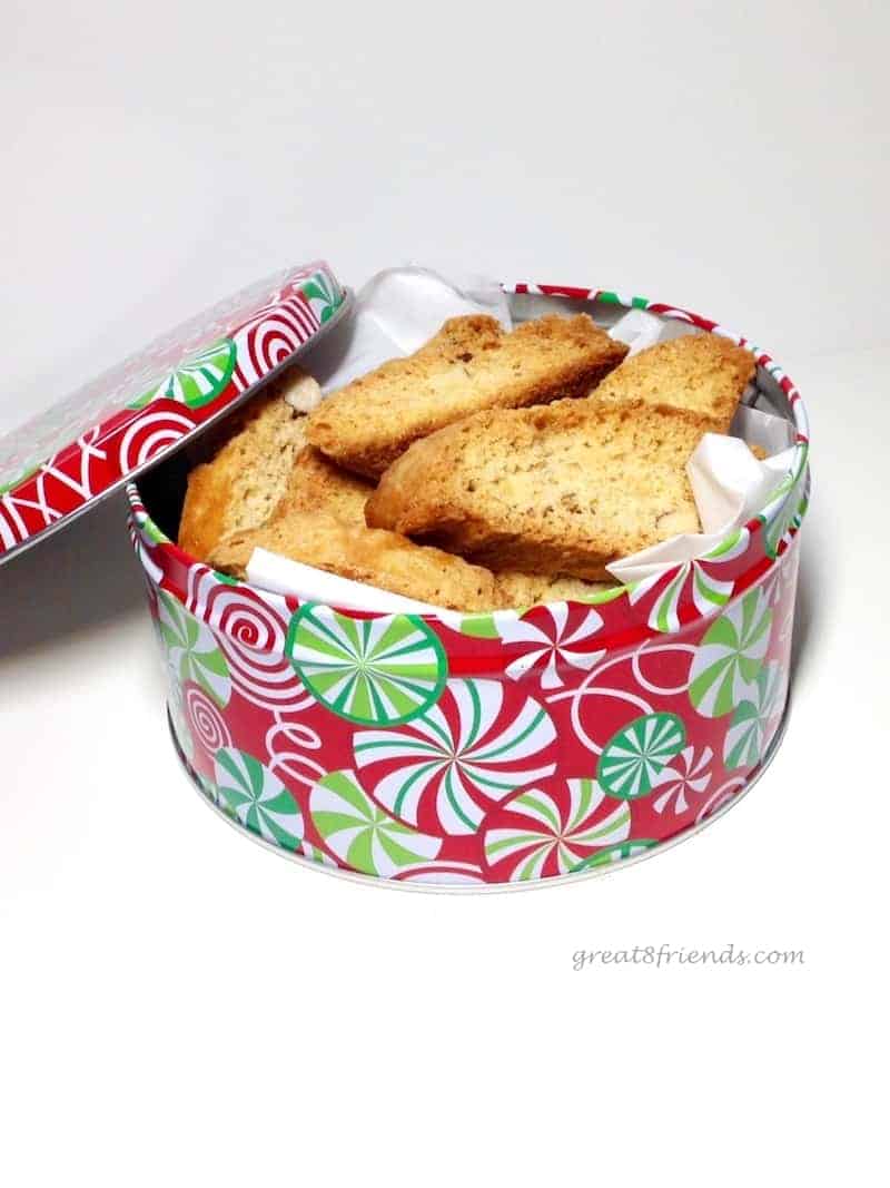 A round christmas tin stuffed with biscotti.