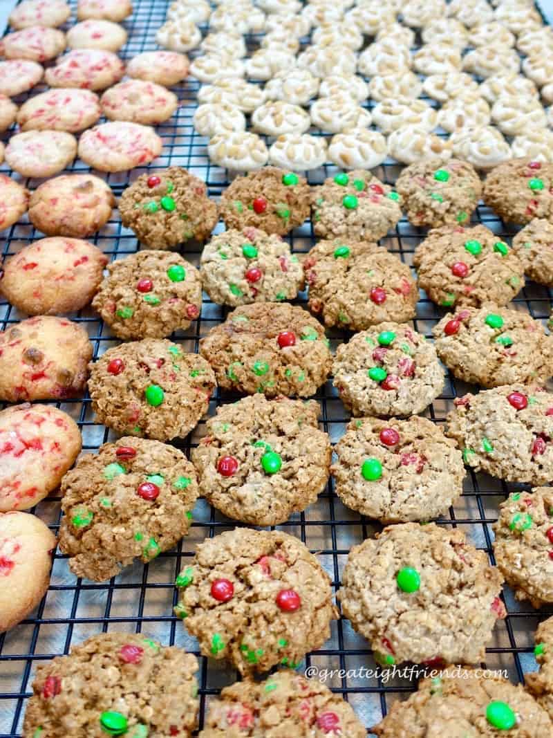 An assortment of Christmas cookie bake cookies cooling on racks.