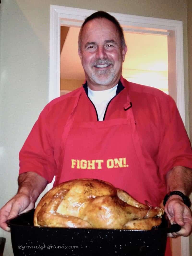 Man holding roast turkey.