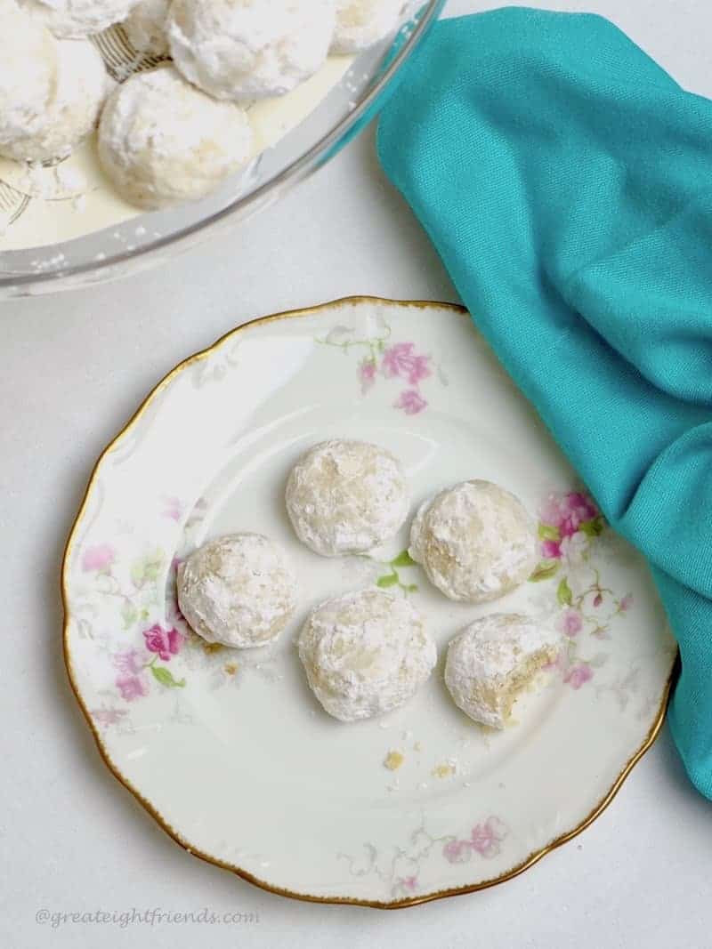 Overhead shot of bite sized wedding cookies on a vintage plate.