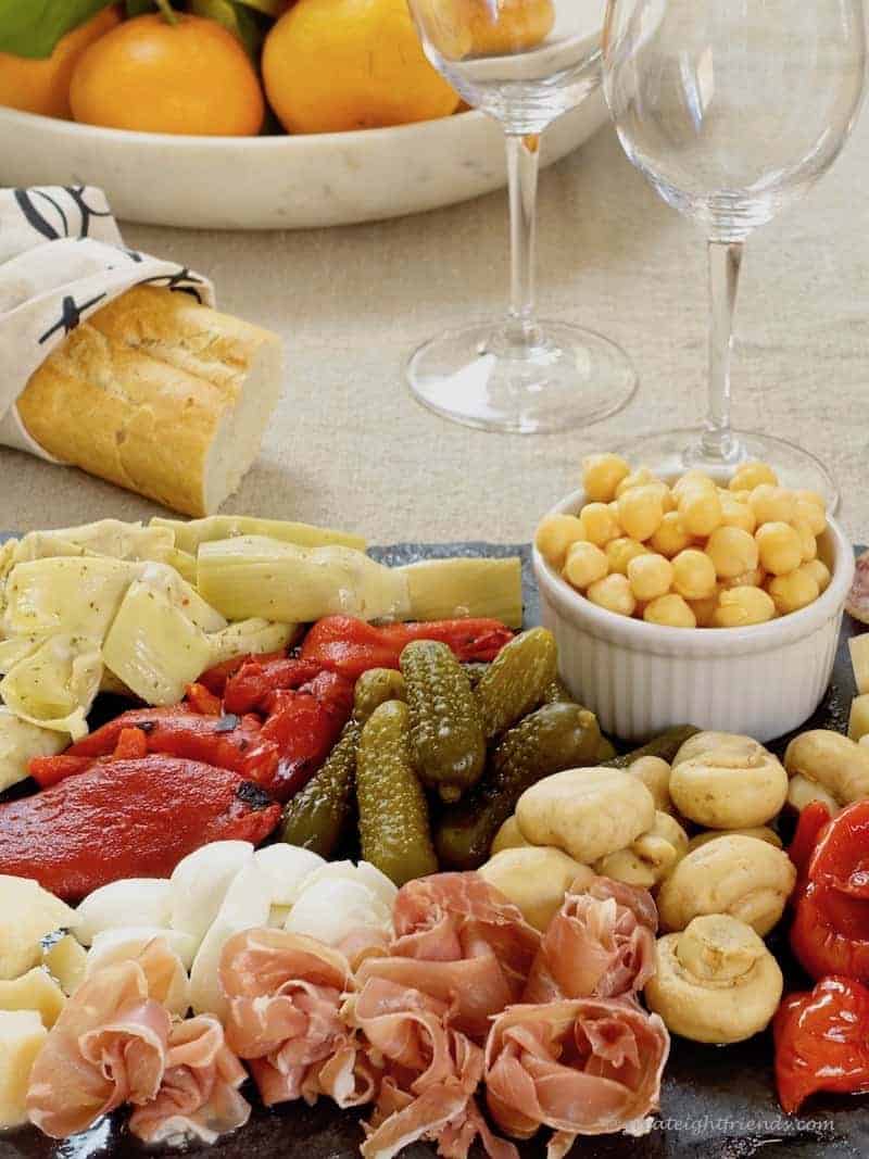 Antipasto platter with bread and wine.