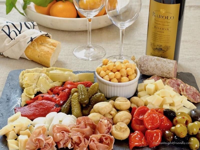 Antipasto platter with bread and wine.