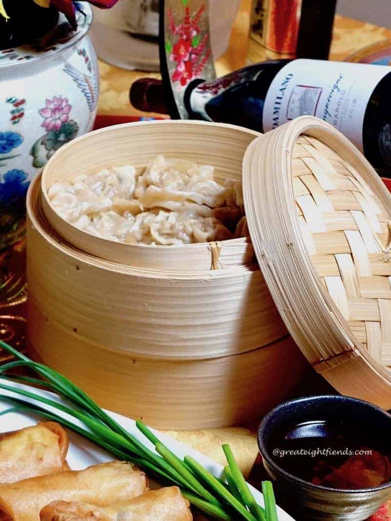 Bamboo steamer holding dumplings.