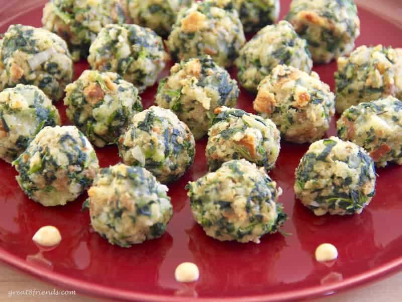 Spinach appetizer balls on a red plate.