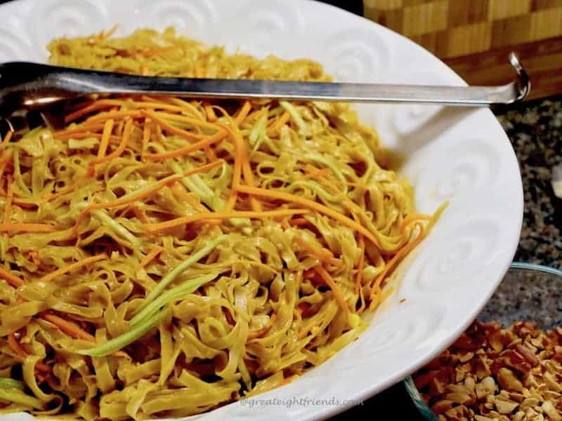 A white bowl filled with sesame noodles.