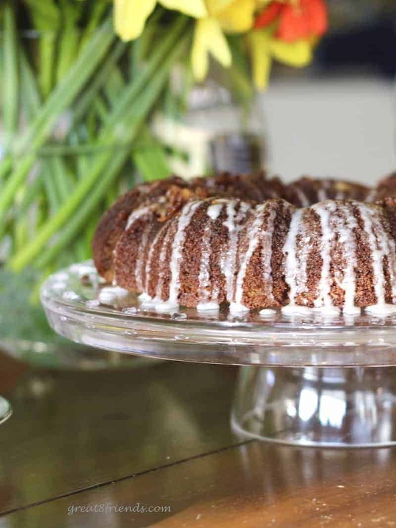 Image of gluten free cinnamon coffee cake with flowers behind.