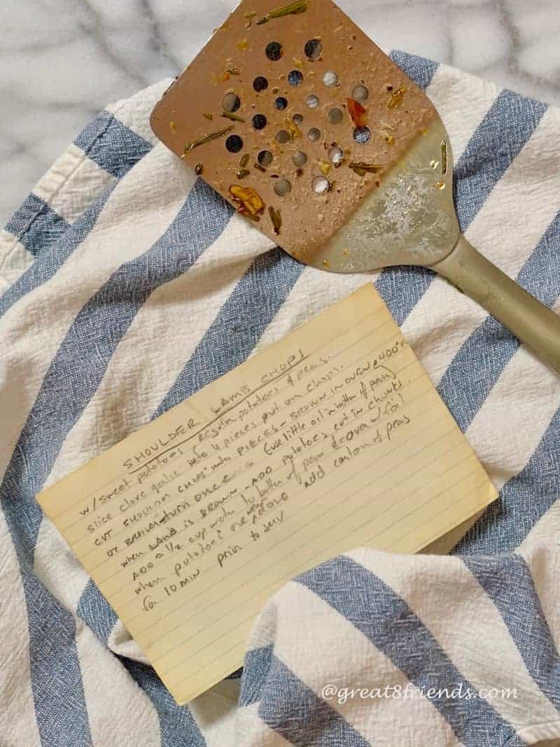 photo of old recipe card, dish towel and spatula.