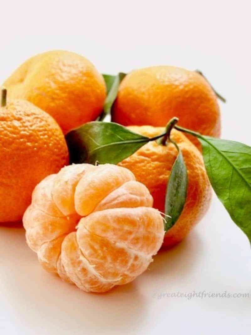 Fresh Tangerines, one is peeled.