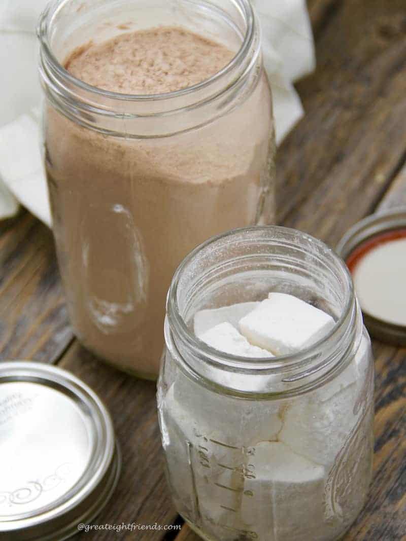 Homemade Hot Cocoa Mix and homemade marshmallows each in a mason jar.