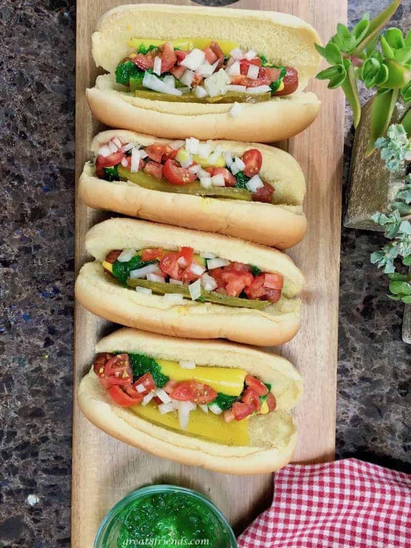 Overhead shot of 4 Chicago style hot dogs all dressed and ready to eat.