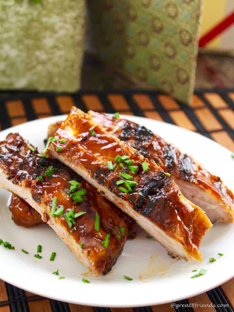 Chinese Style Ribs stacked on a white plate.