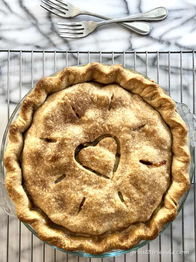 Overhead shot of a baked pie with a heart carved in the crust.